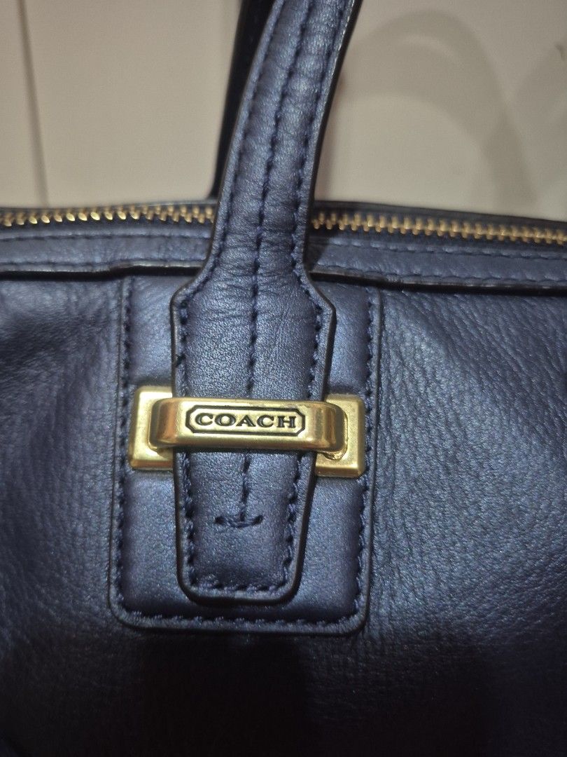 Coach Leather Shoulder Bag with Gold Hardware (Category: Luxury Bags & Wallets) located in Iloilo. Submitted by gorgeoustatz (Listing ID 1470288102, Image 3). Description: - Brand: Coach - Color: Dark blue or black - Material: Premium pebble texture leather - Hardware: Elegant gold-tone zippers and hardware - Branding: Debossed Coach logo on the front - Carry options: Dual top handles and a detachable strap with swivel clasp closure - Structure: 