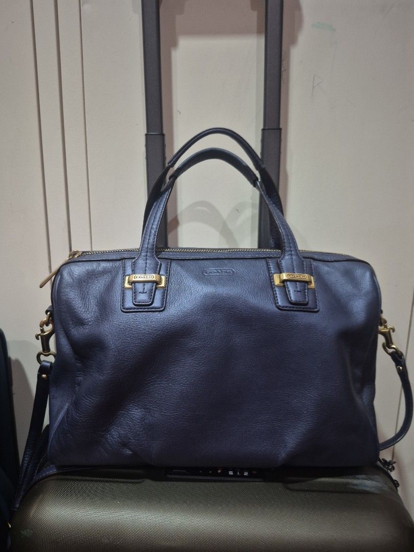 Coach Leather Shoulder Bag with Gold Hardware (Category: Luxury Bags & Wallets) located in Iloilo. Submitted by gorgeoustatz (Listing ID 1470288102, Image 1). Description: - Brand: Coach - Color: Dark blue or black - Material: Premium pebble texture leather - Hardware: Elegant gold-tone zippers and hardware - Branding: Debossed Coach logo on the front - Carry options: Dual top handles and a detachable strap with swivel clasp closure - Structure: 