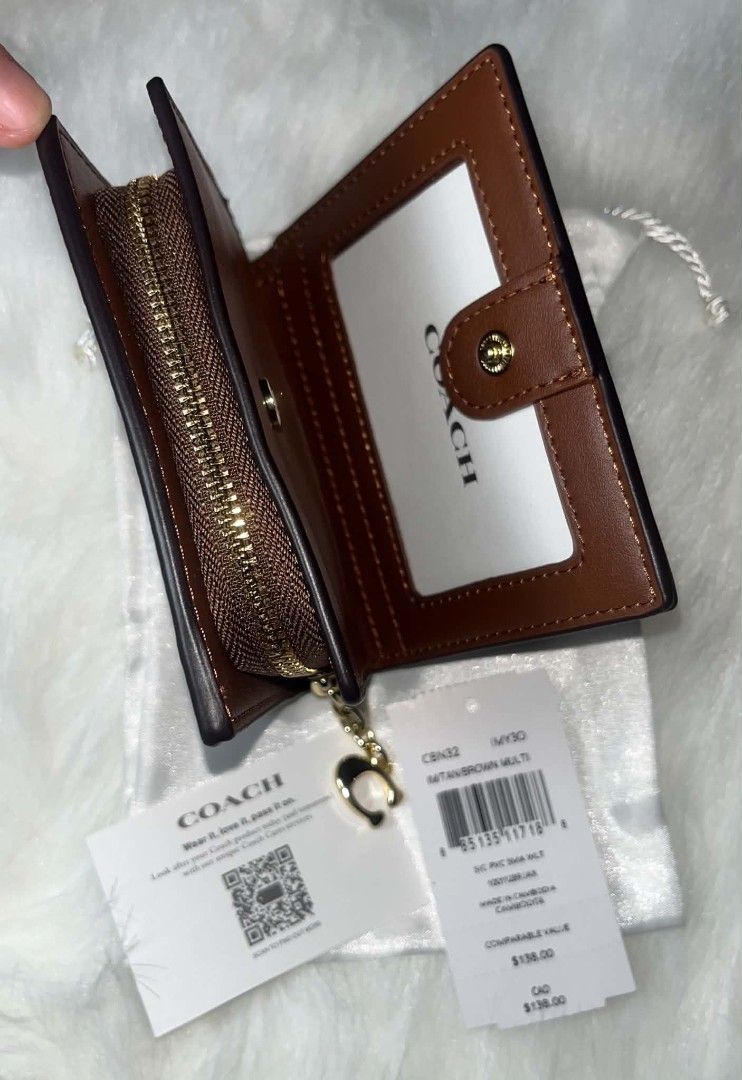 Coach Limited-edition Peanuts Snoopy Snap Wallet Brown Multi (Category: Wallets & Card holders) located in Imus. Submitted by maria_pilayo (Listing ID 1470345423, Image 3). Description: - 💯% Authentic Coach Peanuts Collection Snap Wallet - Material: Signature PVC with Snoopy & Woodstock print - Interior: Brown leather with snap closure - Features: ID window, card slots, and zip coin pocket - Dimensions: Approx. 10.7cm x 9cm - Inclusions: Origina