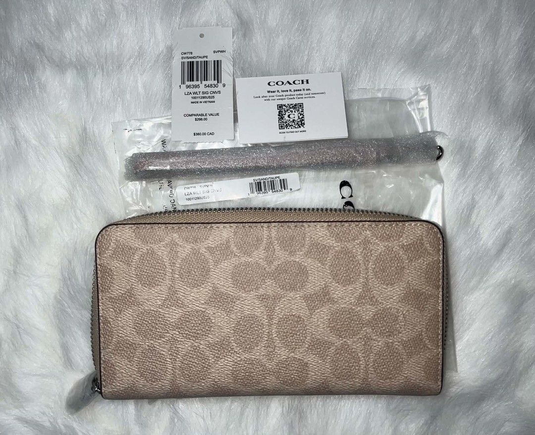 Coach Long Zip Around Wallet Sand Color (Category: Wallets & Card holders) located in Imus. Submitted by maria_pilayo (Listing ID 1470228272, Image 3). Description: - Brand: Coach Long Zip Around Wallet - 💯% Authentic - Color/Design: Sand and Taupe Signature Canvas - Dimensions: 19cm x 10cm - Interior: Multiple card slots and compartments - Inclusions: Detachable wrist strap (wrapped in plastic), original store tags, care card, and packaging - C