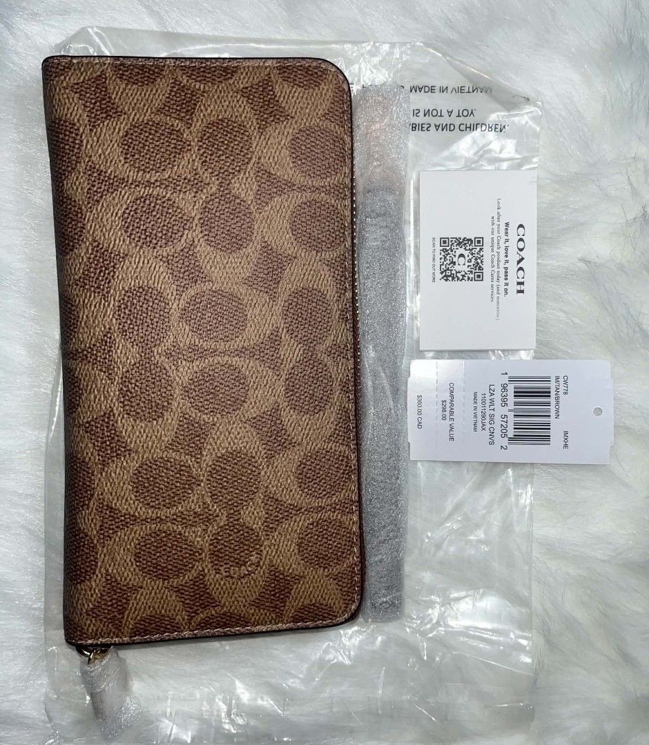 Coach Long Zip Around Wallet Tan Brown (Category: Wallets & Card holders) located in Imus. Submitted by maria_pilayo (Listing ID 1470226799, Image 3). Description: - 💯% Authentic Coach long zip around wallet - Color/Design: Tan brown signature canvas - Size: 19cm x 10cm - Interior: Multiple card slots, compartments, and zippered coin pocket - Inclusions: Original tag, care card, and protective plastic packaging - Quantity: 2 pieces available.