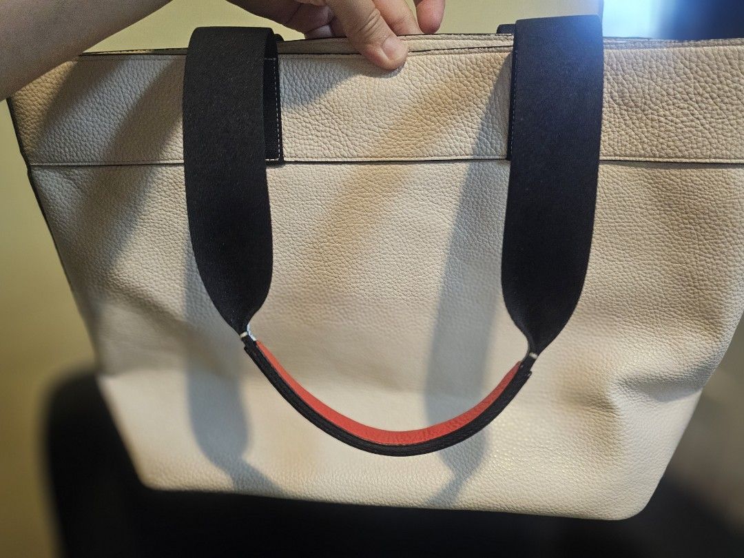 Coach Marvel Captain Marvel Tote Bag White (Category: Tote Bags) located in Las Pinas. Submitted by surplusxchange (Listing ID 1470168787, Image 2). Description: - Authentic Coach leather tote bag - Features a bold Captain Marvel graphic print on the front - Made from textured white pebble leather with black shoulder straps and red underside detail - Secure top snap closure - Brown fabric-lined interior with a zip pocket and Coach creed patch - I