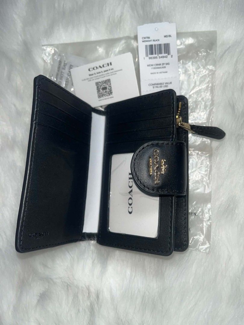 Coach Medium Corner Zip Signature Wallet Midnight Black (Category: Luxury Bags & Wallets) located in Imus. Submitted by maria_pilayo (Listing ID 1470277459, Image 3). Description: - Coach medium corner zip wallet in midnight black. - 💯% Authentic, Brand New - Signature coated canvas texture with smooth leather trim. - Gold-tone hardware and snap closure. - Multiple card slots, cash compartment, and clear ID window. - Includes exterior zippered c
