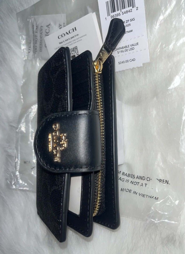 Coach Medium Corner Zip Signature Wallet Midnight Black (Category: Luxury Bags & Wallets) located in Imus. Submitted by maria_pilayo (Listing ID 1470277459, Image 2). Description: - Coach medium corner zip wallet in midnight black. - 💯% Authentic, Brand New - Signature coated canvas texture with smooth leather trim. - Gold-tone hardware and snap closure. - Multiple card slots, cash compartment, and clear ID window. - Includes exterior zippered c