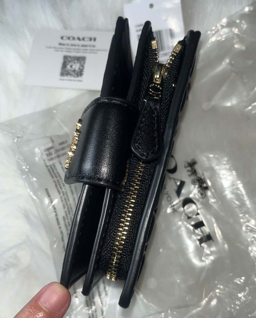 Coach Medium Corner Zip Wallet Black (Category: Wallets & Card holders) located in Imus. Submitted by maria_pilayo (Listing ID 1470279572, Image 2). Description: - Brand: Coach Medium corner zip wallet - 💯% Authentic - Color: Black with signature debossed pattern - Material: Leather with gold-tone hardware - Closure: Snap closure - Features: Multiple card slots, clear ID window, and zip coin pocket - Condition: Brand new with tags and care card 