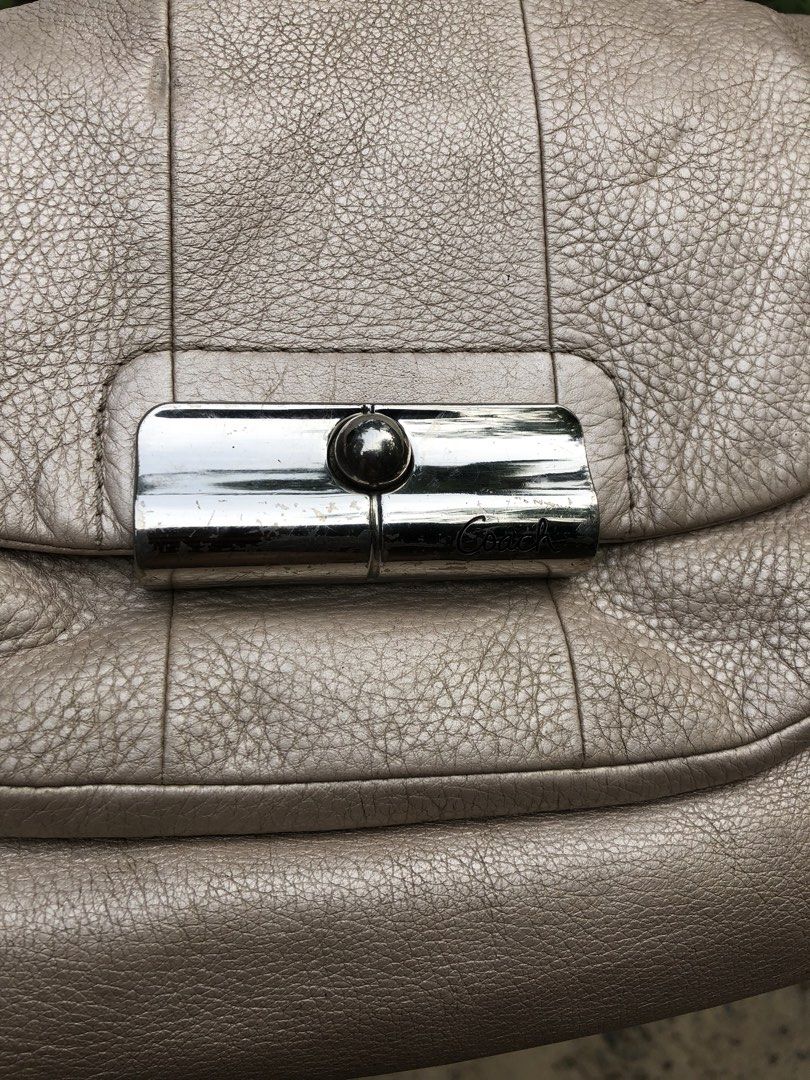 Coach Metallic Gold Leather Shoulder Bag (Category: Luxury Bags & Wallets) located in Montevista. Submitted by rdthriftshub (Listing ID 1470155677, Image 3). Description: - Brand: Coach - Style: Classic hobo shoulder bag - Material: Textured metallic gold leather - Closure: Zip-top opening with front flap and metal turnlock pocket - Details: Includes matching hangtag and interior creed patch with serial number - Interior: Light pink fabric lining