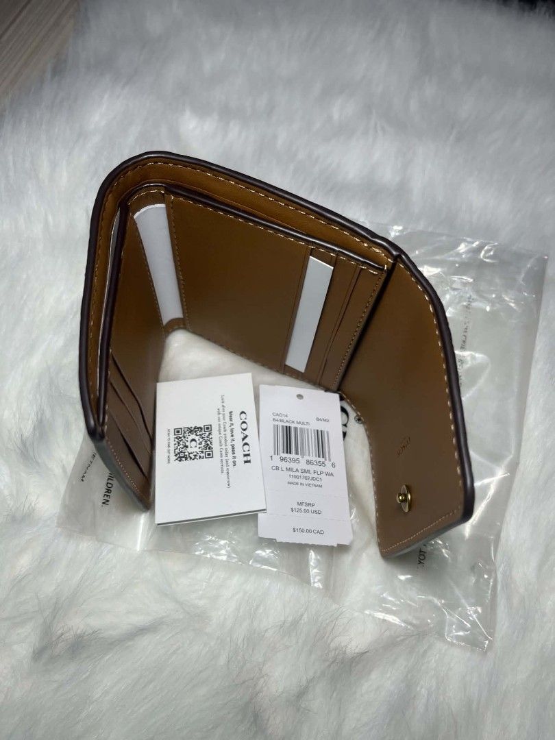 Coach Mila Small Flap Trifold Wallet Black Multi (Category: Luxury Bags & Wallets) located in Imus. Submitted by maria_pilayo (Listing ID 1470221969, Image 2). Description: - Brand: Coach - Style: 💯% Authentic Trifold wallet - Colorway: Black Multi - Dimensions: 11cm x 9.5cm - Features: Multiple card slots, cash compartments, and convenient exterior zip pocket for coins - Condition: Brand new, still in protective plastic packaging - Inclusions: 