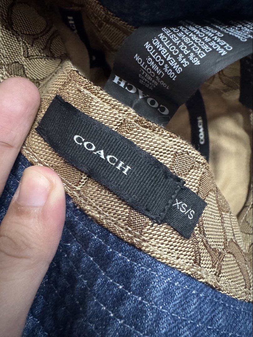 Coach New York Denim Bucket Hat (Category: Babies & Kids Fashion) located in Valenzuela. Submitted by sofiasticated.decluttering (Listing ID 1470171133, Image 3). Description: - Brand: Coach - Style: Denim bucket hat with embroidered white logo - Wash: Classic blue wash denim - Interior: Brown signature C monogram lining with black Coach branding tape - Size: S/S - Condition: Great casual accessory for sunny days out - Shipping or meet-up options