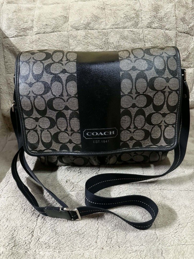 Coach Signature C Black Messenger Bag (Category: Shoulder Bags) located in Quezon City. Submitted by svenalekdhrane_05 (Listing ID 1470247372, Image 1). Description: - Authentic Coach messenger bag - Black and grey signature C monogram pattern - Solid black vertical center stripe with Coach Est. 1941 logo patch - Adjustable black fabric crossbody strap with contrast stitching - Silver-toned hardware - Secure flap closure with spacious compartment