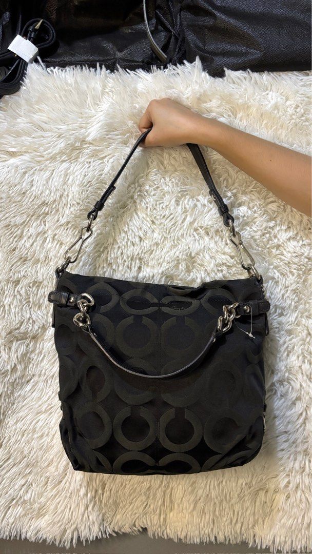 Coach Signature C Black Shoulder Bag (Category: Luxury Bags & Wallets) located in Rizal. Submitted by kianapreloves (Listing ID 1470208867, Image 1). Description: - Authentic Coach black shoulder bag with iconic signature C nylon fabric - Stylish silver hardware and genuine leather trim with matching leather hangtag - Chic double straps featuring trendy chain link details - Adjustable shape with convenient side snap closures - Spacious main compa