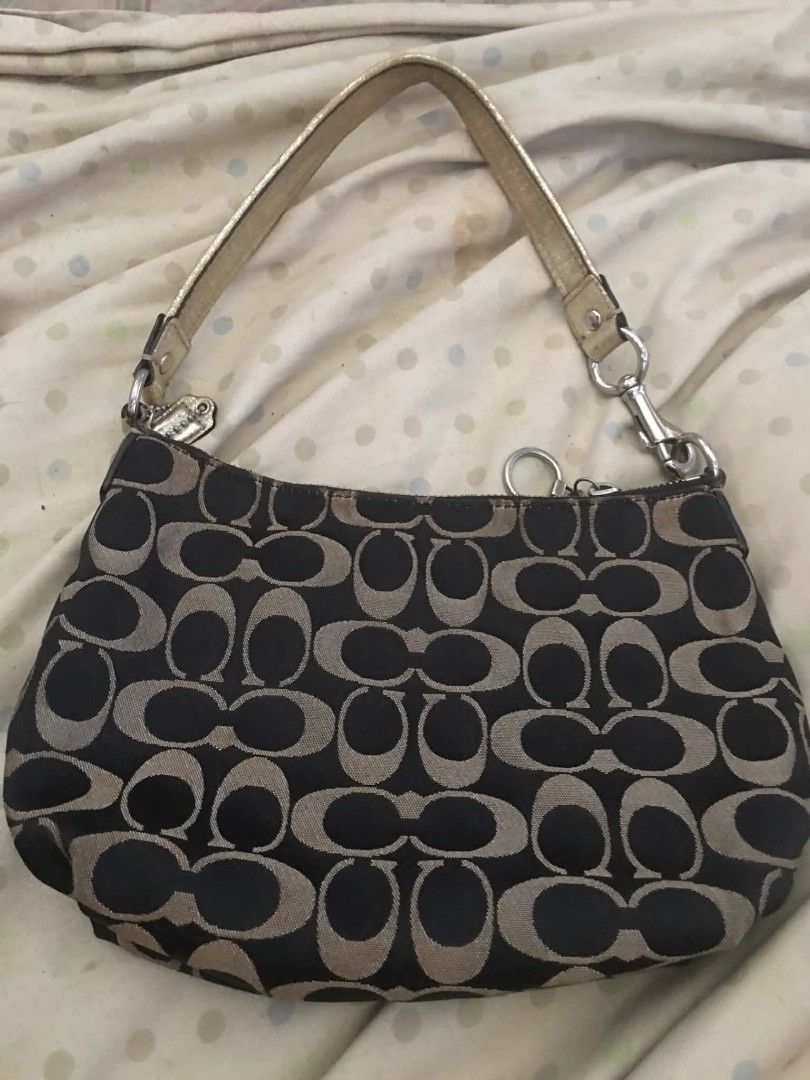 Coach Signature C Monogram Shoulder Bag (Category: Luxury Bags & Wallets) located in Lingayen. Submitted by myrahpasil83880 (Listing ID 1470154438, Image 1). Description: - Authentic Coach signature C monogram shoulder bag - Color: Black and tan canvas with metallic gold leather handles and trim - Hardware: Silver-tone with branded zipper pullers - Includes original side hangtag - Features a convenient double-zip compartment on the back - Compact