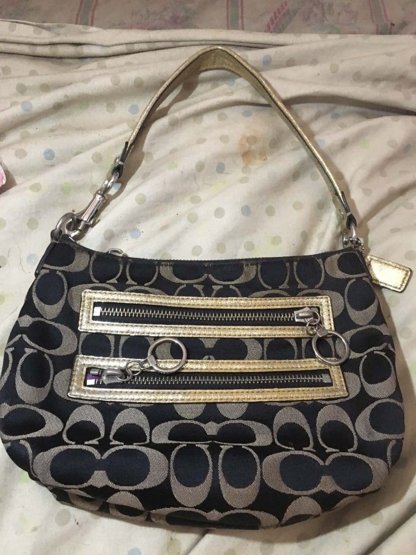 Coach Signature C Monogram Shoulder Bag (Category: Luxury Bags & Wallets) located in Lingayen. Submitted by myrahpasil83880 (Listing ID 1470154438, Image 2). Description: - Authentic Coach signature C monogram shoulder bag - Color: Black and tan canvas with metallic gold leather handles and trim - Hardware: Silver-tone with branded zipper pullers - Includes original side hangtag - Features a convenient double-zip compartment on the back - Compact