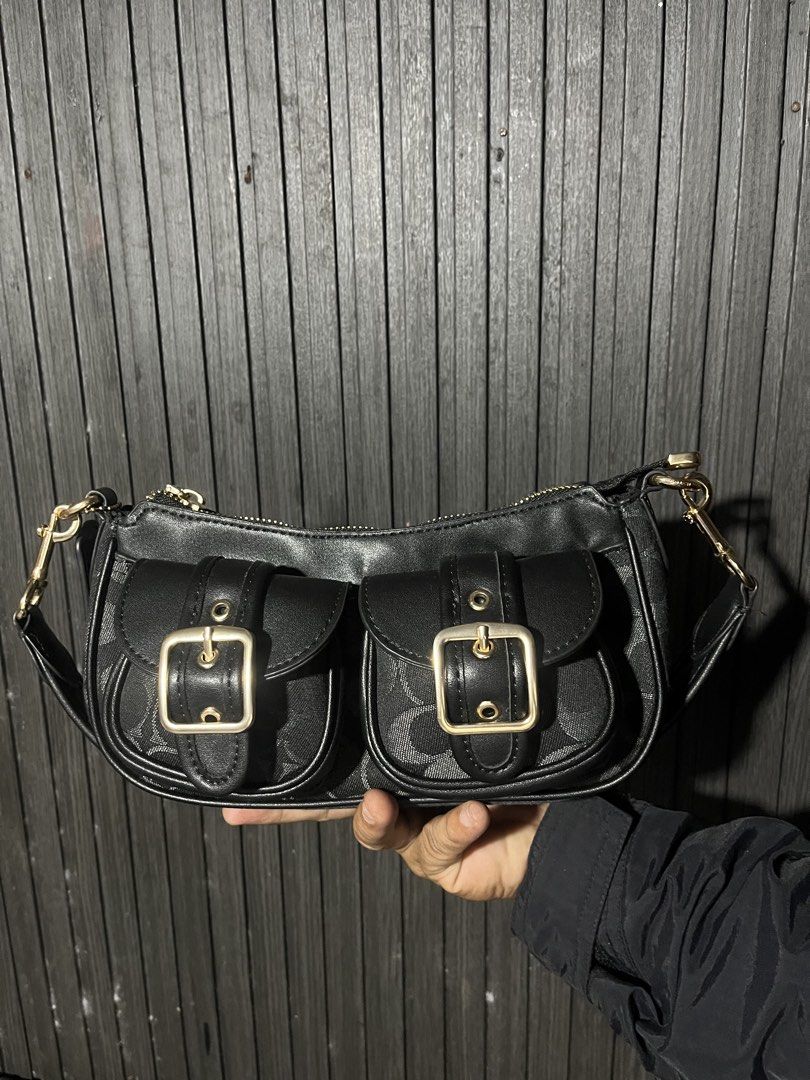 Coach Signature Monogram Black Shoulder Bag with Front Pockets (Category: Luxury Bags & Wallets) located in Manila. Submitted by thrift_kasakin (Listing ID 1470191280, Image 1). Description: - Brand: Coach - Color: Classic black with signature monogram fabric - Hardware: Gold-tone metal buckles and accents - Storage: Two front flap pockets and a secure zip top closure - Strap: Short black strap with gold clasps on both ends - Condition: Clean ext