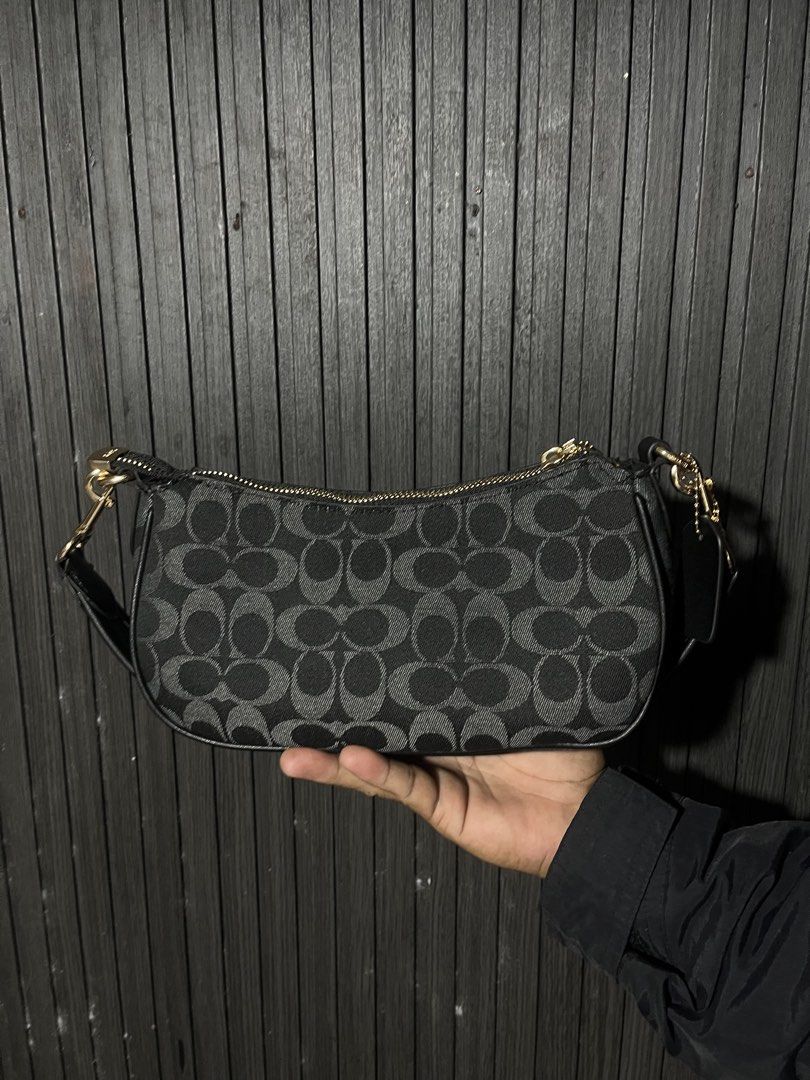 Coach Signature Monogram Black Shoulder Bag with Front Pockets (Category: Luxury Bags & Wallets) located in Manila. Submitted by thrift_kasakin (Listing ID 1470191280, Image 2). Description: - Brand: Coach - Color: Classic black with signature monogram fabric - Hardware: Gold-tone metal buckles and accents - Storage: Two front flap pockets and a secure zip top closure - Strap: Short black strap with gold clasps on both ends - Condition: Clean ext