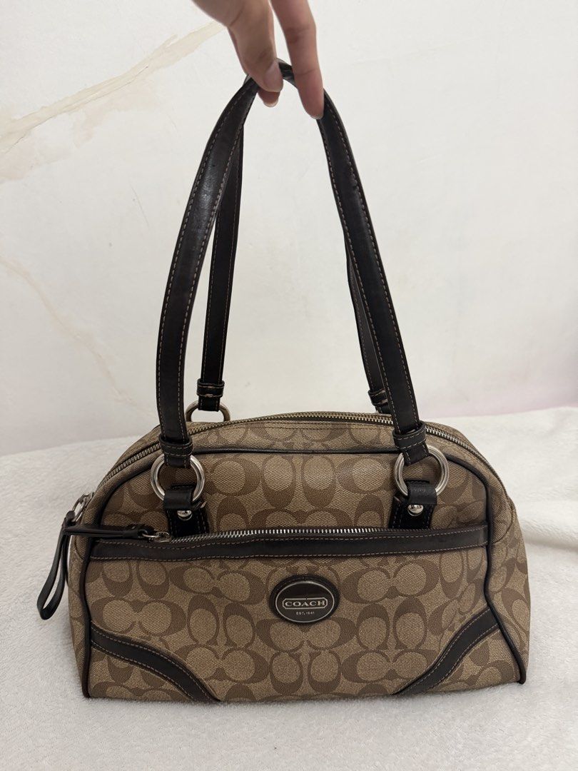 Coach Signature Satchel Handbag (Category: Luxury Bags & Wallets) located in Dasmarinas. Submitted by charoaso (Listing ID 1470173935, Image 1). Description: Coach Signature monogram shoulder bag - Color: Brown fabric with dark brown leather trim - Hardware: Silver-tone issue: lining rfs: for vet expense .