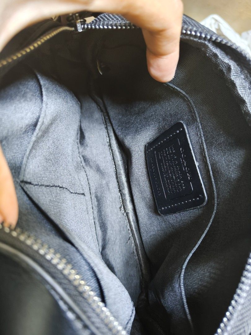 Coach Signature Stripe Camera Bag Black Brown (Category: Luxury Bags & Wallets) located in Davao. Submitted by navil01 (Listing ID 1470313646, Image 2). Description: - Brand: Coach - Material: Black leather and signature monogram canvas with brown center stripe - Hardware: Dark gunmetal - Compartments: Double zipped main compartments - Interior: Fabric lining with slip pockets and brand patch - Strap: Adjustable black fabric strap - Origin: Made 