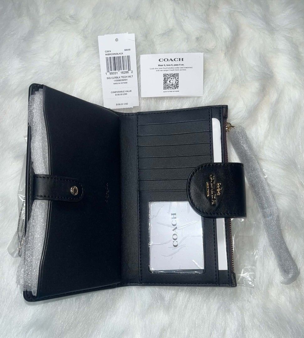 Coach Tech Phone Wallet Brown/Black (Category: Wallets & Card holders) located in Imus. Submitted by maria_pilayo (Listing ID 1470281656, Image 3). Description: - Brand: Coach - 💯% Authentic - Model: C2874 SIG CLRBLK TECH WLT - Colorway: Brown (Signature Colorblock) - Dimensions: 19cm (L) x 10.5cm (H) - Features: Multiple card slots and convenient wrist strap - Condition: Brand new in plastic packaging - Inclusions: Original tags and care card i