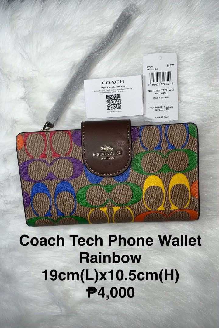 Coach Tech Phone Wallet Rainbow (Category: Wallets & Card holders) located in Imus. Submitted by maria_pilayo (Listing ID 1470280777, Image 1). Description: - 💯% Authentic Coach Tech Phone Wallet in Signature Canvas - Features a vibrant rainbow print with chic brown leather trim and gold-tone hardware - Dimensions: 19cm x 10.5cm - Includes a convenient wrist strap for easy carrying - Interior features multiple card slots and a clear ID window - 