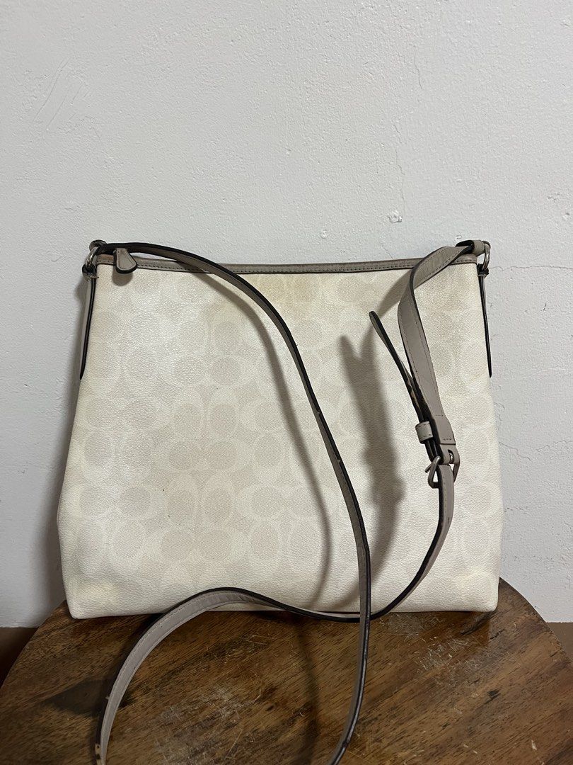Coach Varsity Stripe Messenger Crossbody Bag (Category: Luxury Bags & Wallets) located in Cabuyao City. Submitted by rdtrmt (Listing ID 1470198165, Image 2). Description: - Brand: Coach - Style: Crossbody bag - Color/Design: Off-white signature C monogram with vertical orange and yellow center stripes - Trim & Hardware: Gray trim with silver-tone hardware - Interior: Bright yellow fabric lining with a convenient interior zip pocket - Exterior: Fr