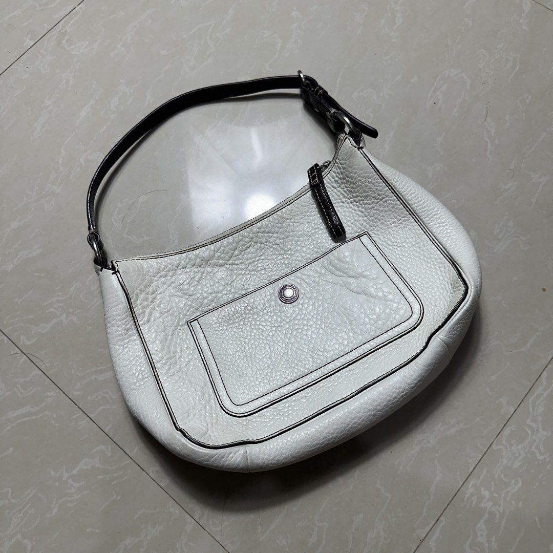 Coach White Pebbled Leather Shoulder Bag (Category: Luxury Bags & Wallets) located in Manila. Submitted by direcmampu37948 (Listing ID 1470244932, Image 1). Description: - Brand: Coach - Material: White pebbled leather with dark brown strap and zipper pull - Hardware: Silver-tone with YKK zippers - Features: Single top handle and front exterior pocket with turnlock closure - Condition: Clean body with minor signs of previous use - Style: Chic, ve