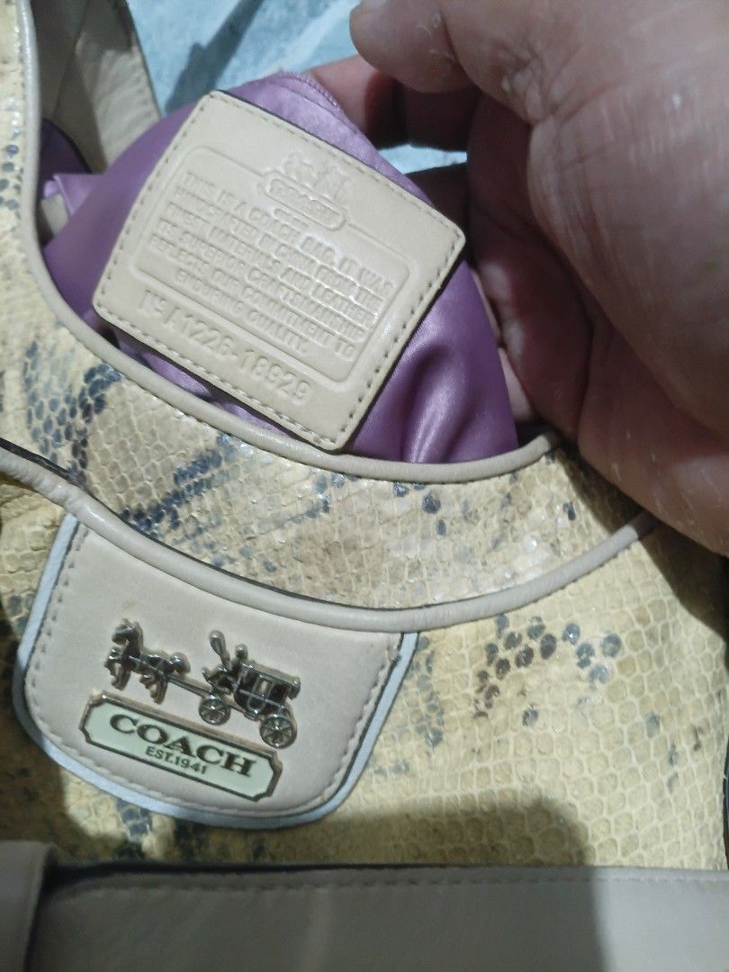 Coach Yellow Snake Print Shoulder Bag (Category: Luxury Bags & Wallets) located in Cavite. Submitted by jaimebuala31560 (Listing ID 1470192913, Image 3). Description: - Authentic Coach shoulder bag - Yellow and grey snake print pattern with smooth beige leather straps - Front flap closure with metal horse and carriage logo plate - Vibrant purple fabric interior lining - Includes interior leather creed patch with serial number F1226-18929 - Perfec