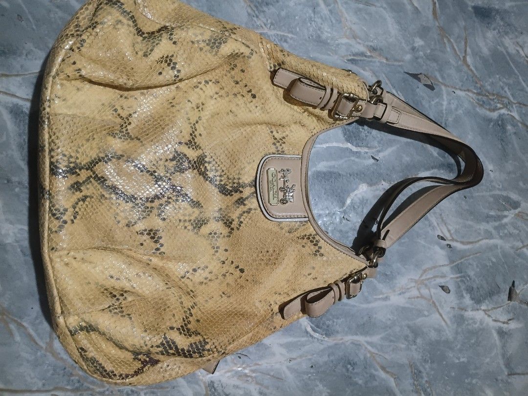 Coach Yellow Snake Print Shoulder Bag (Category: Luxury Bags & Wallets) located in Cavite. Submitted by jaimebuala31560 (Listing ID 1470192913, Image 1). Description: - Authentic Coach shoulder bag - Yellow and grey snake print pattern with smooth beige leather straps - Front flap closure with metal horse and carriage logo plate - Vibrant purple fabric interior lining - Includes interior leather creed patch with serial number F1226-18929 - Perfec