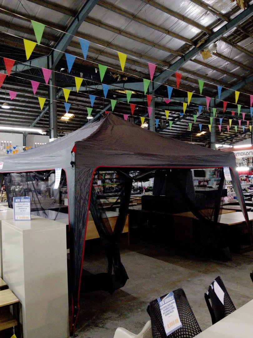 Coleman Gazebo with Integrated Lighting & 4-Sided Meshwalls (Category: Outdoor Furniture) located in Manila. Submitted by kamanowkhmr (Listing ID 1470172569, Image 1). Description: - Coleman gazebo on display, featuring a stylish grey canopy with red trim - Built-in integrated lighting system for convenient nighttime use - Four-sided mesh walls to keep bugs out while allowing a cool breeze in - Spacious interior layout ideal for outdoor gathering