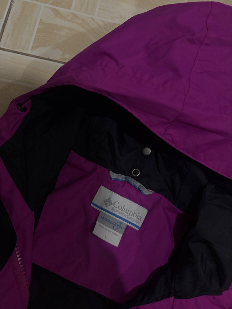Columbia Interchange Purple Hooded Jacket Size L (Category: Coats, Jackets and Outerwear) located in Alaminos. Submitted by outfitcheck.ph (Listing ID 1470298613, Image 3). Description: - Brand: Columbia Interchange - Color: Bright purple with black interior lining - Size: L (Made in Vietnam) - Features: Attached hood with adjustable drawcords, full zip front with protective placket, and two zippered side pockets - Condition: Clean, excellent ove
