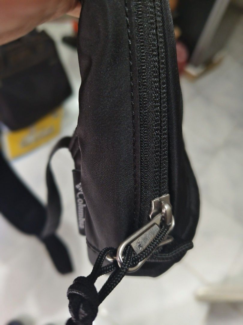 Columbia PU8732 Black Sling Bag (Category: Sling Bags) located in Sariaya. Submitted by queen_1213 (Listing ID 1470171298, Image 3). Description: - Brand: Columbia - Model: PU8732 (Made in Vietnam) - Color: Black with stylish light blue interior lining - Comfort: Single adjustable strap with breathable mesh backing and D-ring attachment - Pockets: Front zipper pocket with patterned cord pull plus an interior security zip pocket - Details: Subtle 