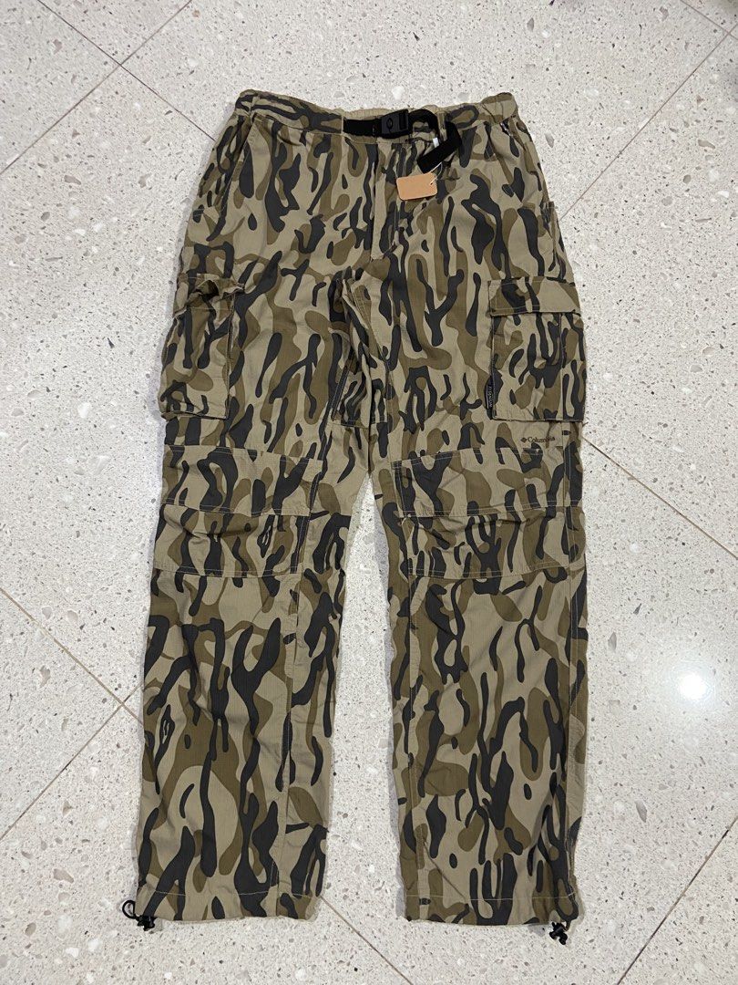 Columbia Titanium Camo Cargo Pants Men M (Category: Trousers) located in Calumpit. Submitted by Ketchi (Listing ID 1470262022, Image 1). Description: - Brand: Columbia Titanium - Style: Cargo pants in green camo pattern - Size: Men's Medium - Material: 100% durable nylon ripstop fabric - Fit: Elastic waistband with integrated adjustable buckle belt and drawstring leg openings - Storage: Multiple functional cargo pockets - Details: Branded embroid