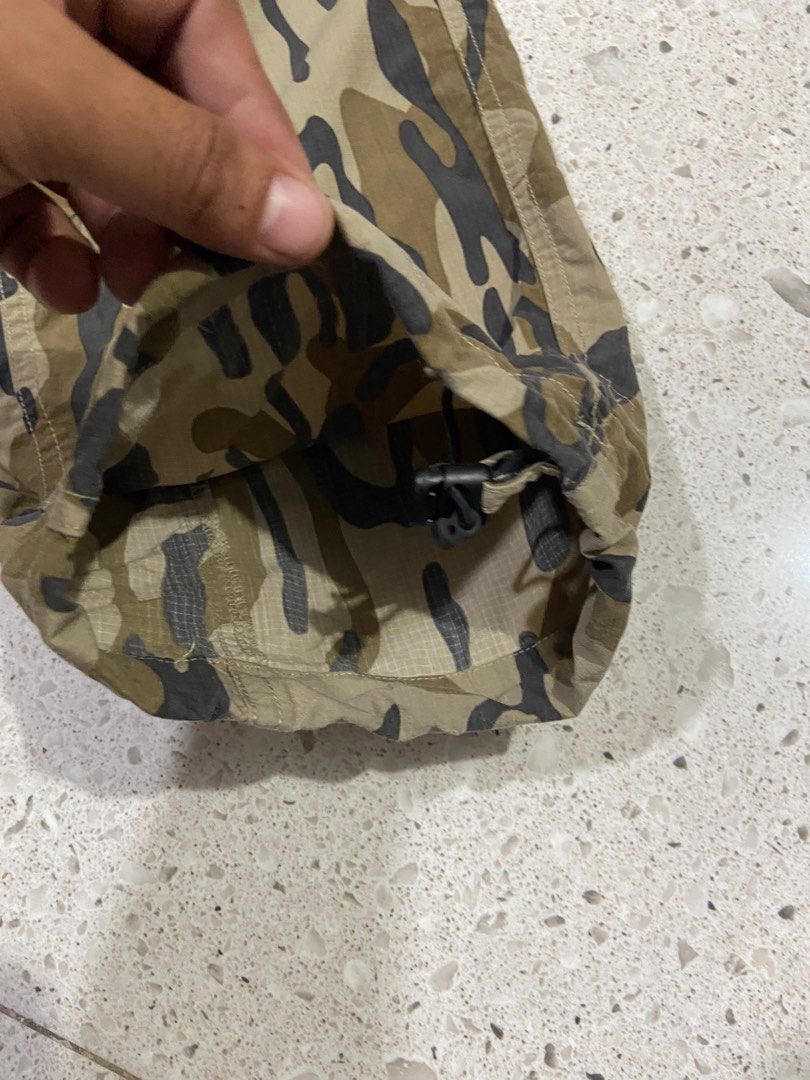 Columbia Titanium Camo Cargo Pants Men M (Category: Trousers) located in Calumpit. Submitted by Ketchi (Listing ID 1470262022, Image 2). Description: - Brand: Columbia Titanium - Style: Cargo pants in green camo pattern - Size: Men's Medium - Material: 100% durable nylon ripstop fabric - Fit: Elastic waistband with integrated adjustable buckle belt and drawstring leg openings - Storage: Multiple functional cargo pockets - Details: Branded embroid