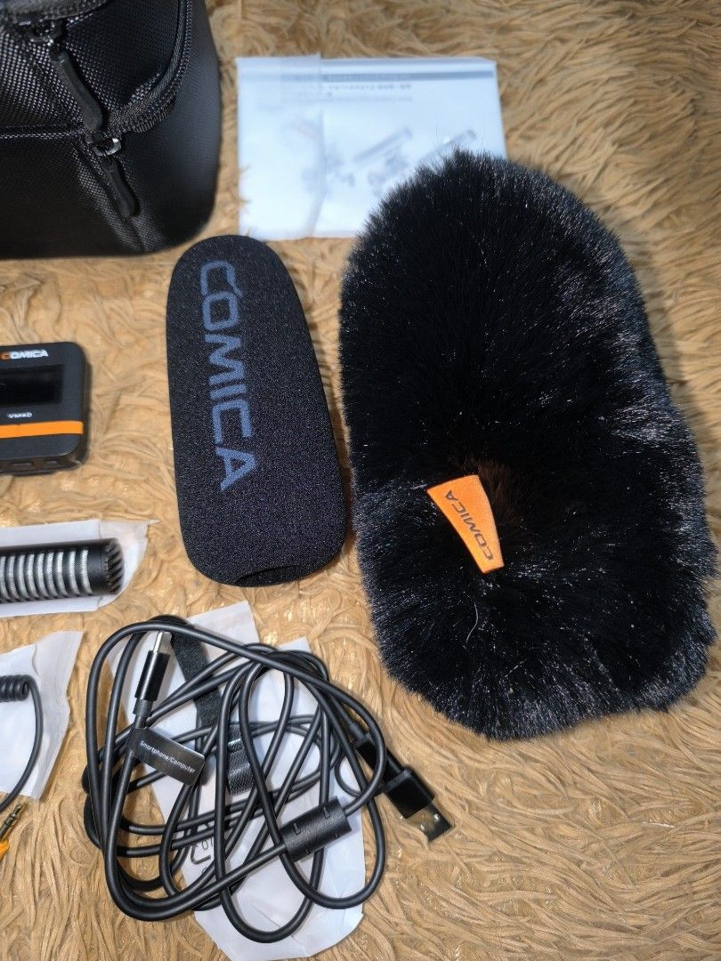 Comica VM40 Shotgun Microphone Wireless Receiver Set (Category: Microphones) located in Manila. Submitted by adindin.1212 (Listing ID 1470241991, Image 2). Description: Comica VM40 directional microphone kit. Includes the main shotgun mic, wireless receiver unit, shock mount, multiple audio cables, foam windscreen, furry deadcat windshield, and carry case. Everything laid out neatly on the rug. Tested and working great, screen lights up clearly. 