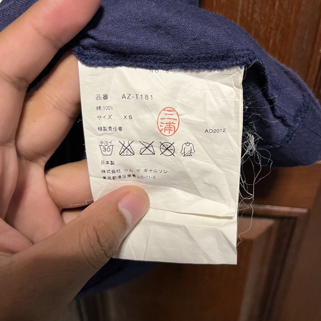 COMME des GARÇONS PLAY T-Shirts (Category: Shirts) located in Manila. Submitted by thriftyyyyy. (Listing ID 1470290220, Image 3). Description: - Authentic COMME des GARÇONS PLAY t-shirts (Made in Japan, 100% cotton, hand wash only) - Item 1: White short-sleeve tee with multi-heart & camo graphics, Size M (AD2019) - Item 2: Dark blue tee with large outline heart graphic, Size XS (AD2012) - Features classic PLAY branding on collar tags - DM for inq