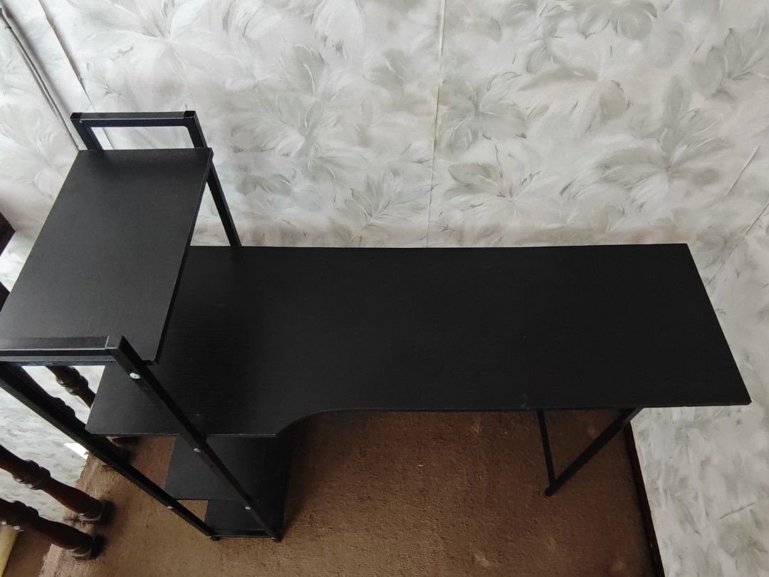 Computer desk with integrated bookshelves / study table (Category: Tables & Sets) located in Paranaque City. Submitted by anonymoosh (Listing ID 1470228497, Image 3). Description: - Design: Stylish black metal frame with brown wooden surfaces - Storage: Built-in multi-tier shelving unit on the side for extra space - Dimensions: 100 cm (L) x 31 cm (W) x 104 cm (H) - Condition: Clean and well-maintained with no issues - Reason for selling: Upgraded