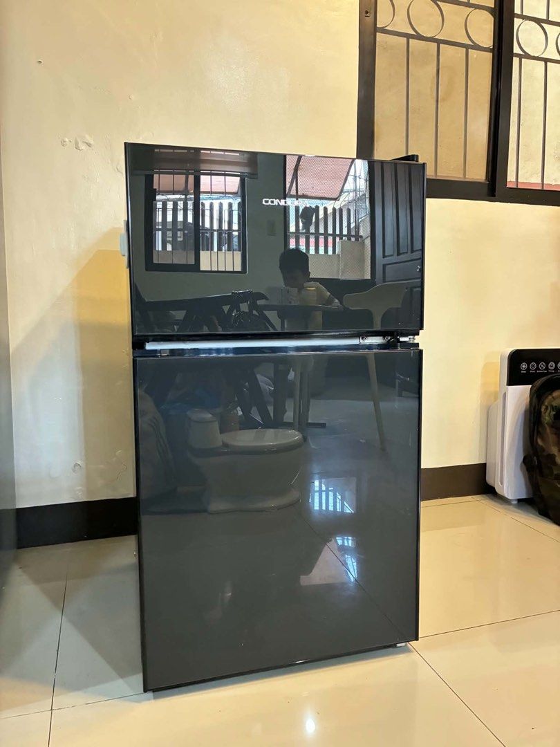 Condura Two Door Refrigerator Black (Category: Refrigerators and Freezers) located in Quezon City. Submitted by krengkreng (Listing ID 1470170485, Image 3). Description: - Brand/Model: Condura two-door refrigerator in sleek black - Condition: Good working order, keeps items cold with no issues; normal signs of use on the exterior - Size: Compact design, ideal for small spaces like condo units, dorms, or apartments - Interior: Very clean, includes