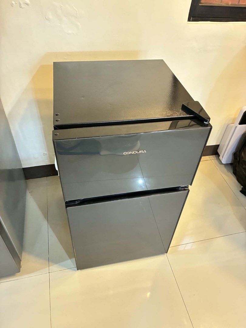 Condura Two Door Refrigerator Black (Category: Refrigerators and Freezers) located in Quezon City. Submitted by krengkreng (Listing ID 1470170485, Image 2). Description: - Brand/Model: Condura two-door refrigerator in sleek black - Condition: Good working order, keeps items cold with no issues; normal signs of use on the exterior - Size: Compact design, ideal for small spaces like condo units, dorms, or apartments - Interior: Very clean, includes