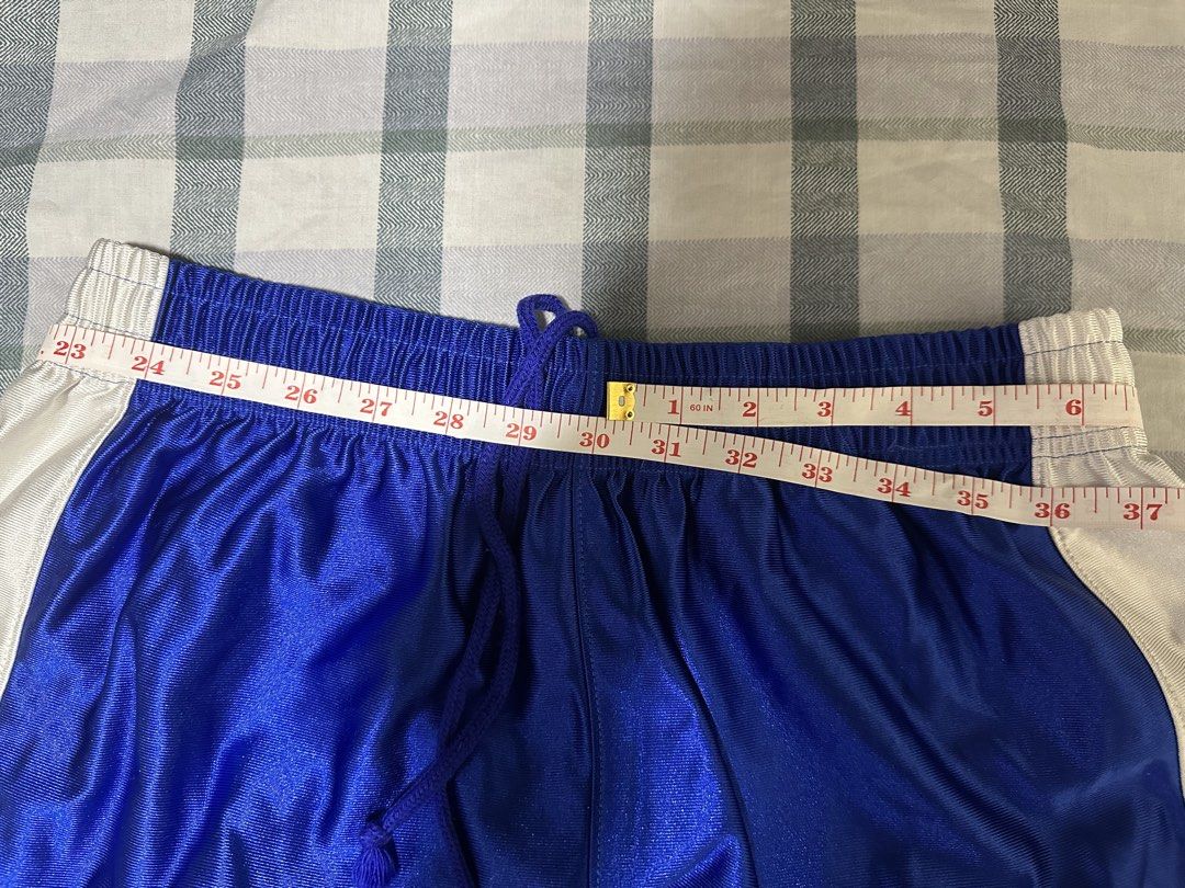 Converse Competition Blue White Basketball Shorts (Category: Shorts) located in Manila. Submitted by shoriljane (Listing ID 1470288711, Image 2). Description: - Brand: Converse Competition - Style Code: CB2380 - Color: Royal blue with white side panels and drawstrings - Size: Men's O JASPO - Features: Elastic waist with working drawstring, mesh inserts near the hem, and printed Converse star logo on the left leg - Condition: Clean fabric with bri