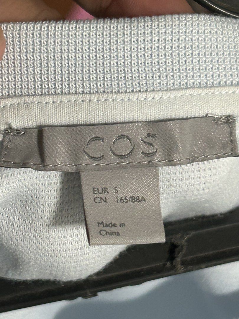 COS Light Blue Two-Tone Top Size S (Category: Longsleeves) located in Cavite. Submitted by florabells (Listing ID 1470273329, Image 2). Description: - Brand: COS - Color: Light Blue and White (Two-Tone) - Size: EUR S (CN 165/88A) - Fit: Relaxed fit with round neckline - Design: Contrasting fabric panel at bottom hem and cuffs - Condition: Pre-loved, with some yellowish stains on the back side as shown in photos - Origin: Made in China.