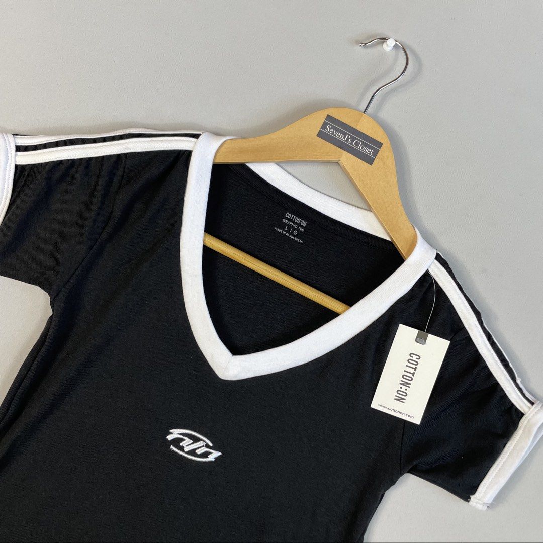 COTTON ON | Minimalist Black V-Neck Ringer Tee (Category: Shirts) located in Norzagaray. Submitted by sevenjscloset (Listing ID 1470280014, Image 2). Description: - Brand: Cotton On - Style: Minimalist black v-neck ringer tee with white contrast trim - Details: Embroidered graphic branding on the chest - Size: Tagged Large (Length: 20 inches, Width: 13 inches) - Model Reference: 5’2” height , 50kg weight.