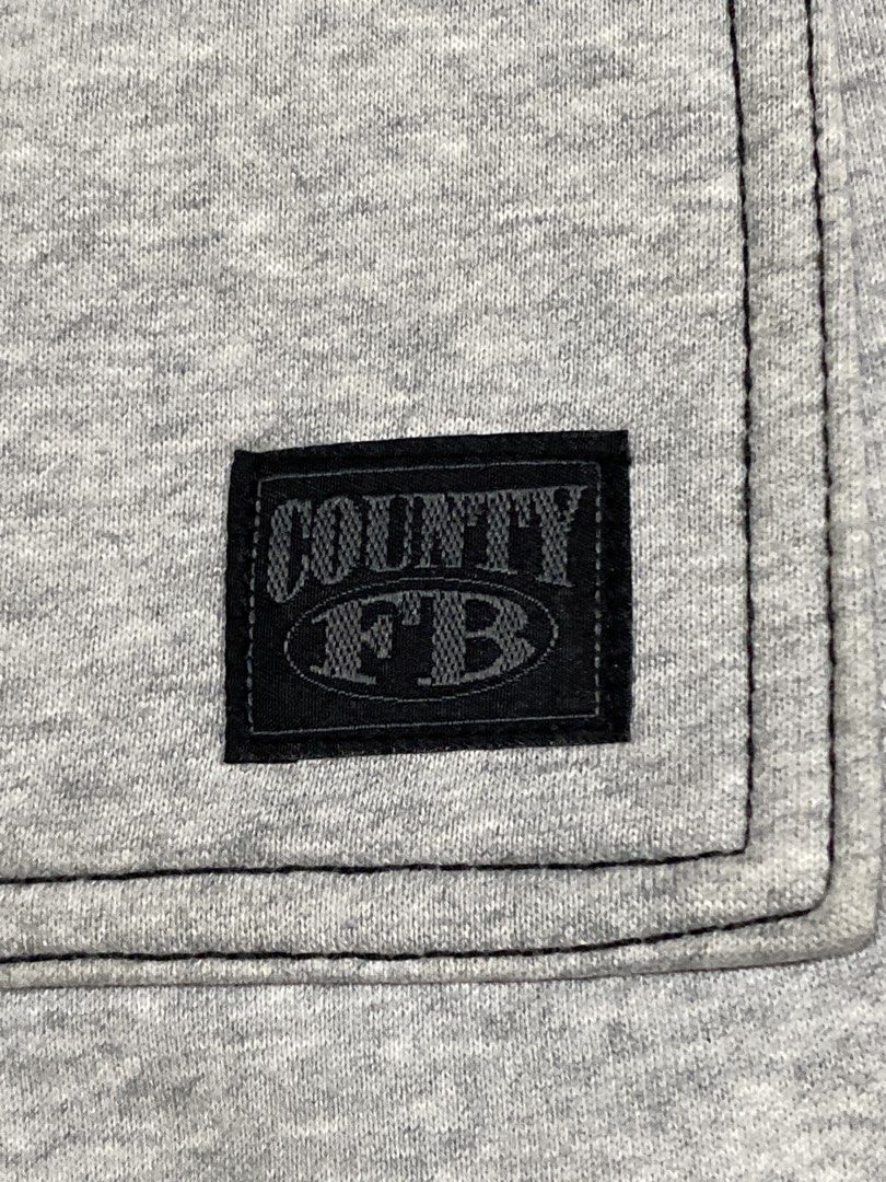 County FB Grey Cargo Sweatpants Size L (Category: Joggers) located in Caloocan City. Submitted by camarcenin42067 (Listing ID 1470289933, Image 3). Description: - Brand: County FB - Style: Cargo sweatpants - Color: Heather Grey - Size: Large (L) - Material: Thick fleece lining inside - Features: Multiple side and back pockets, branded drawstring with metal aglets, adjustable cinch cords at leg openings - Condition: Clean piece, worn only a few ti