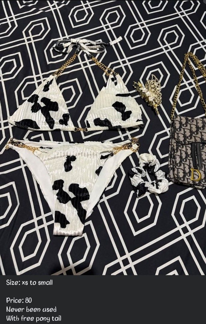 Cow print bikini set with chain strap detail (Category: Bikinis & Swimsuits) located in Manila. Submitted by chelshoppe (Listing ID 1470178561, Image 1). Description: - Style: Cow print bikini set with black and white pattern - Material: Textured velvet fabric - Details: Features glamorous gold chain straps on top and bottoms - Size: Fits extra small to small (XS-S) - Condition: Never worn out, brand new .