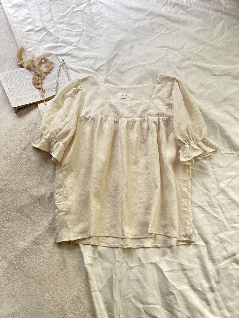 Cream Square Neck Puff Sleeve Blouse Medium 38 (Category: Blouses) located in Poro. Submitted by joyceyuu (Listing ID 1470167487, Image 1). Description: - Color: Cream - Style: Square neckline, gathered bust, and short puff sleeves with ruffled cuffs - Fit: Relaxed fit through the body - Fabric: Soft, textured, and lightweight - Versatility: Easy to pair with high-waisted jeans or skirts - Condition: Excellent, worn only a few times with no flaws