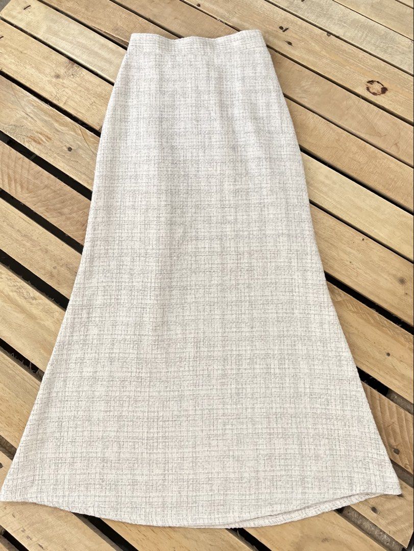 Cream textured skirt with back zip (Category: Skirts) located in Santa Rosa. Submitted by thrifty_bev (Listing ID 1470294585, Image 3). Description: - Color & Texture: Cream and grey textured fabric - Comfort & Closure: Smooth full lining, side zipper, and partial elastic waistband at the back - Condition: Clean inside and out - Versatility: Perfect for workwear or casual weekend outfits.