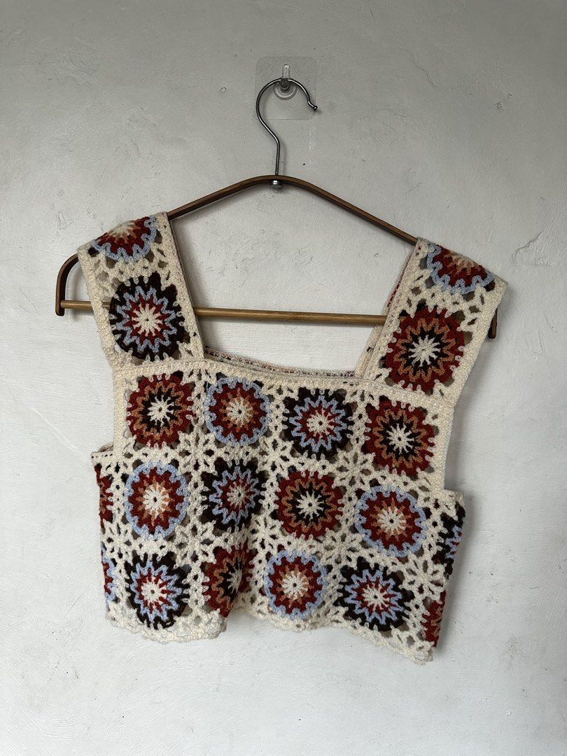 Crochet Grannysquare Crop Top (Category: Sleeveless) located in Manila. Submitted by omelette.12 (Listing ID 1470245151, Image 1). Description: - Used it twice - Cream base with rust, brown, and light blue granny square patterns - Square neckline and wide straps - Lightweight knit material, ideal for warm weather or layering - Clean and well-maintained condition.