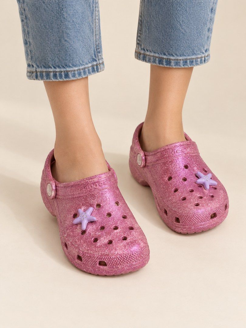 Crocs Classic Glitter Clog (Category: Sandals) located in Santa Rosa. Submitted by ninaparis (Listing ID 1470220118, Image 1). Description: Original Crocs Classic Glitter Clog size W9 M7 With free 2 Jibitz color purple.