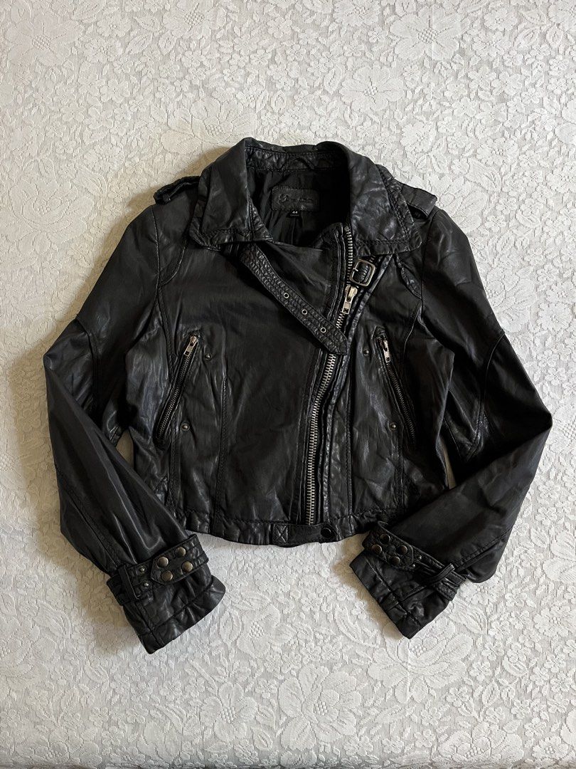 Cropped Black leather biker jacket (Category: Coats, Jackets and Outerwear) located in Baguio. Submitted by dutefinds (Listing ID 1470347373, Image 1). Description: - Style: Black leather motorcycle jacket with asymmetrical front zipper - Hardware: Silver-tone zippers, pockets, and cuff snaps - Details: Adjustable buckle on the lapel and back hem - Interior: Fully lined with black fabric - Size: Tagged Size 44 - Condition: Excellent pre-loved con