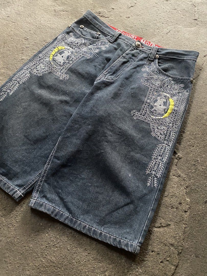 Crown Holder Embroidered Denim Jorts Y2K (Category: Shorts) located in Caloocan City. Submitted by remythrift (Listing ID 1470188348, Image 2). Description: - Brand/Model: Crown Holder denim jorts - Wash: Dark wash - Details: Heavy white and yellow embroidery on front panels and back waistband, detailed stitching on back pockets - Lining: Red inner waistband lining - Condition: Minor fraying and small repair near the hem and button area - Style: 