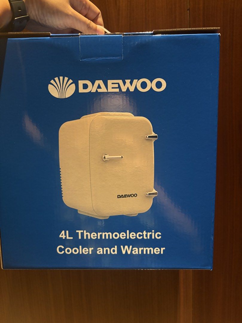 Daewoo 4L Thermoelectric Cooler and Warmer (Category: Refrigerators and Freezers) located in Valenzuela. Submitted by rhen0901 (Listing ID 1470218471, Image 1). Description: - Brand: Daewoo - Capacity: 4-litre mini cooler and warmer - Condition: Brand new, unopened, and sealed in box - Design: Compact white body with stylish retro chrome handle and hinges - Ideal for: Desks, bedrooms, dorm rooms, small offices, and keeping drinks cold or food war