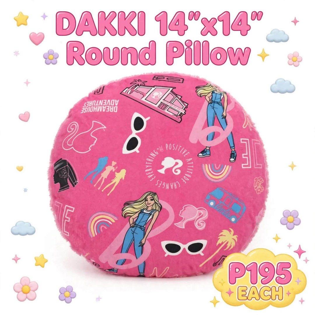 DAKKI 14"x14" Barbie Round Pillow (Category: Cushions & Throws) located in San Fernando. Submitted by mahreefer1987 (Listing ID 1470309154, Image 1). Description: - Brand: Dakki - Size: 14x14 inches, Round shape - Design: Vibrant pink with all-over Barbie graphics (sunglasses, palm trees, and iconic logo) - Material: Super soft and comfortable fabric - Use: Perfect accent piece for beds, sofas, and room setups.