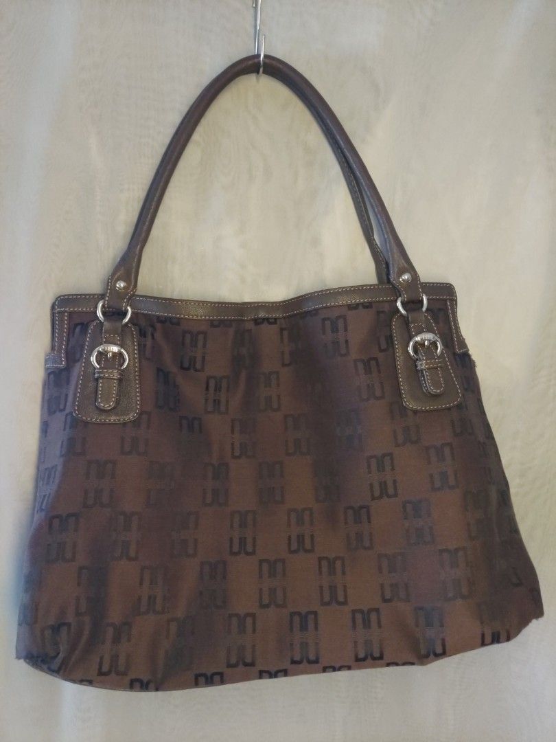 DAKS Brown Monogram Shoulder Bag (Category: Shoulder Bags) located in Quezon City. Submitted by never_a_clutter (Listing ID 1470168418, Image 1). Description: - Authentic DAKS shoulder bag in classic brown monogram - Durable leather trim, handles, and base reinforcement - Features stylish dual shoulder straps and buckle accent hardware - Spacious interior that easily fits daily essentials - gold hardware super minimal scratch - corners few rubs, 